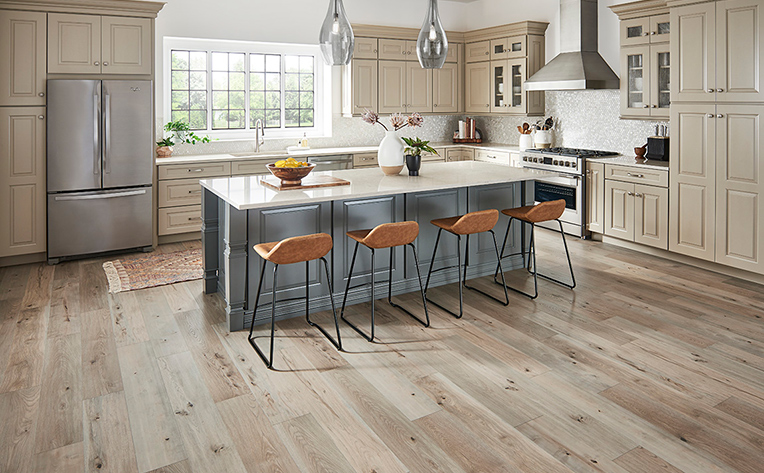 Modern and light colored open concept kitchen with wood look flooring